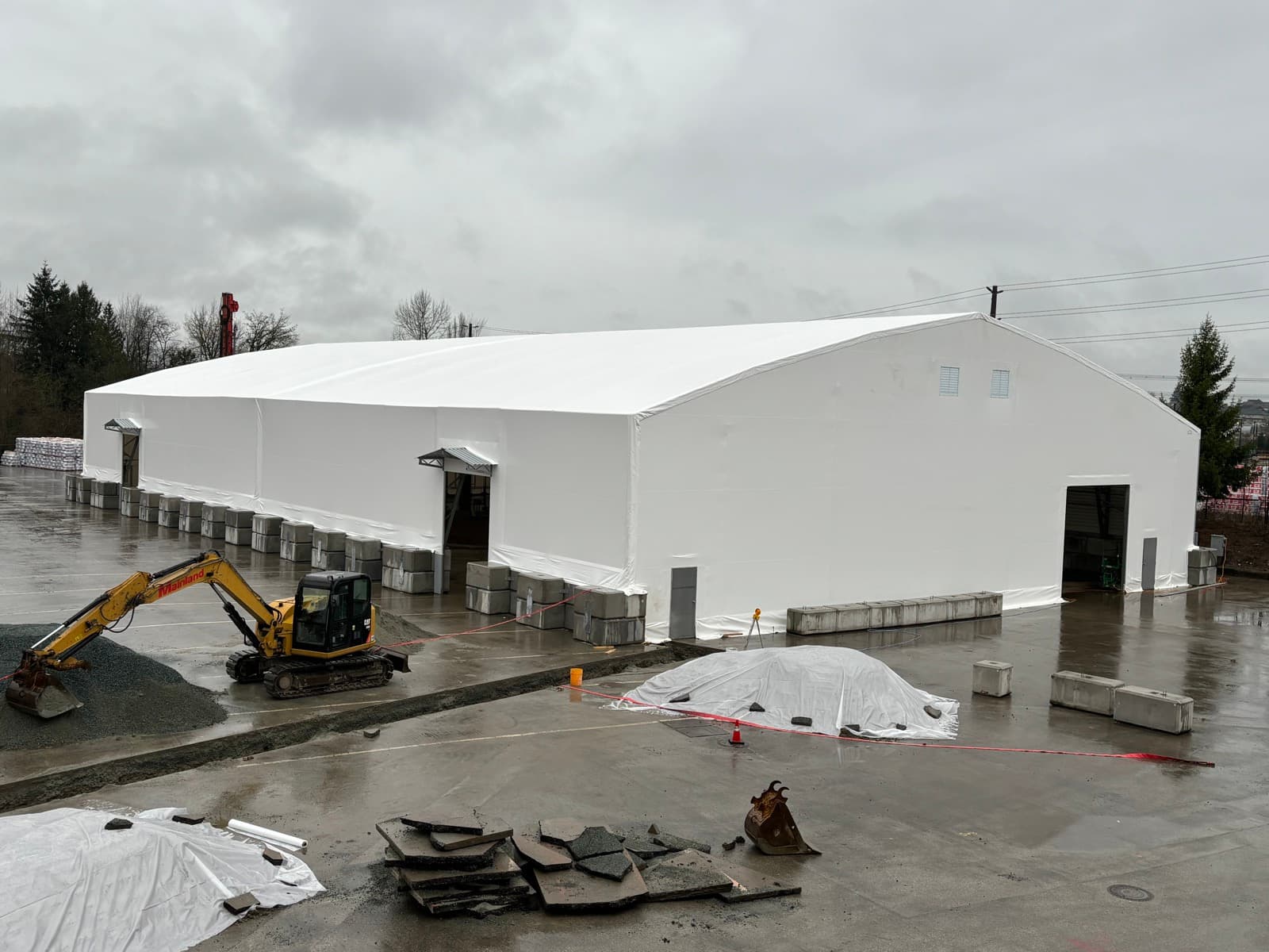 Large-span fabric-covered structure during installation on a commercial site.