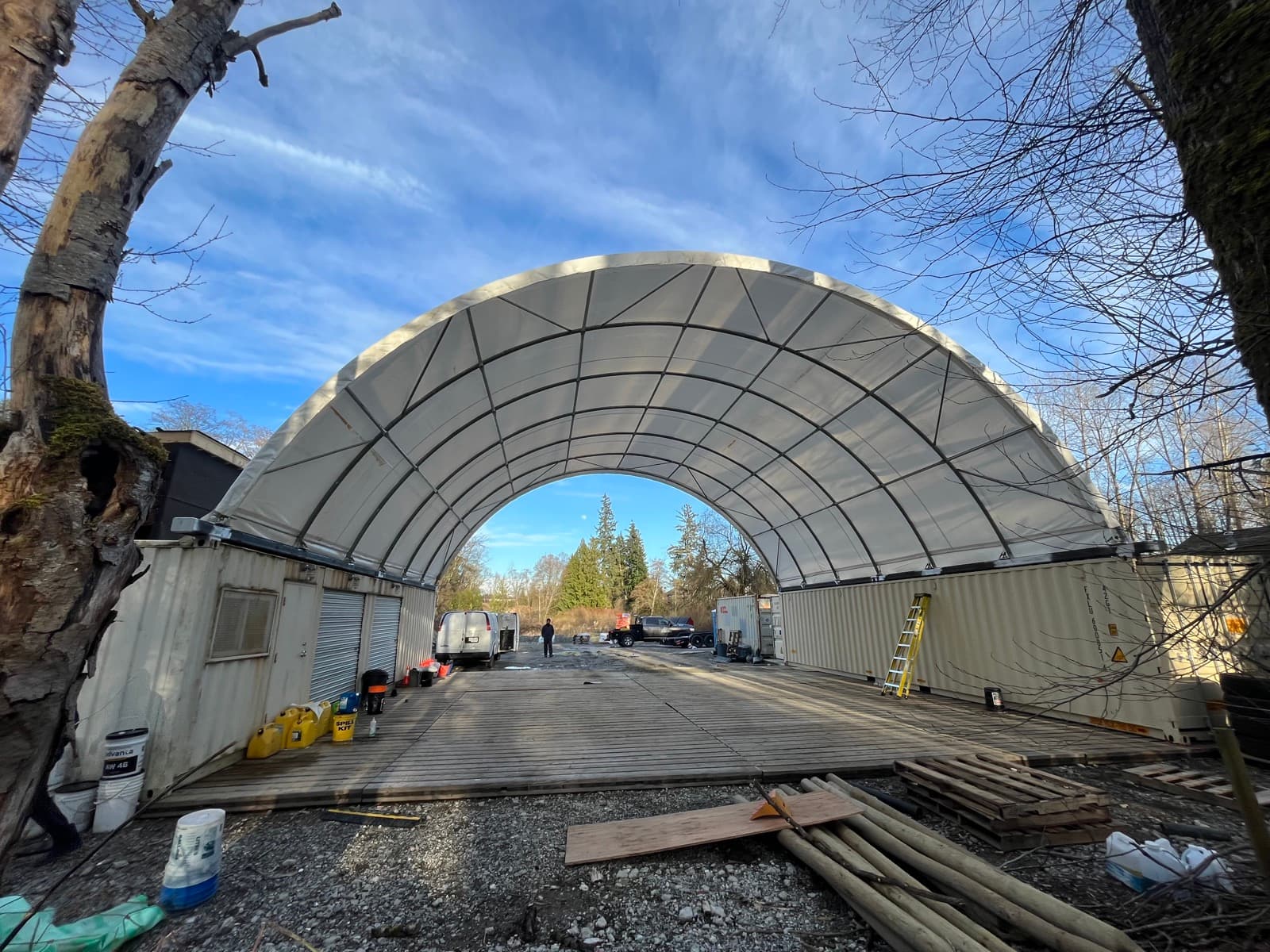 Steel structure frame installation continuing through winter site conditions.